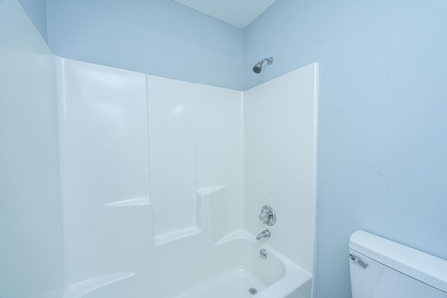 bathroom with toilet and washtub / shower combination