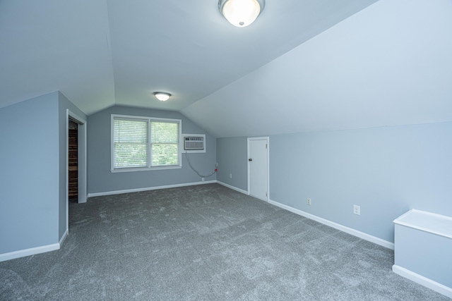 bonus room featuring carpet flooring, vaulted ceiling, baseboards, and a wall unit AC