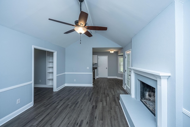 unfurnished living room featuring dark wood-type flooring, a ceiling fan, vaulted ceiling, a fireplace with raised hearth, and baseboards