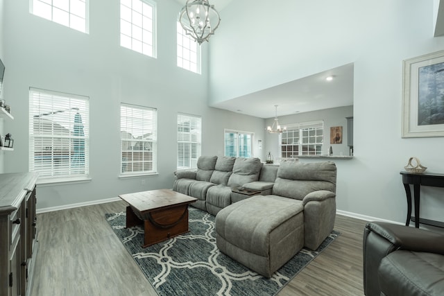 living room featuring wood-type flooring and a chandelier