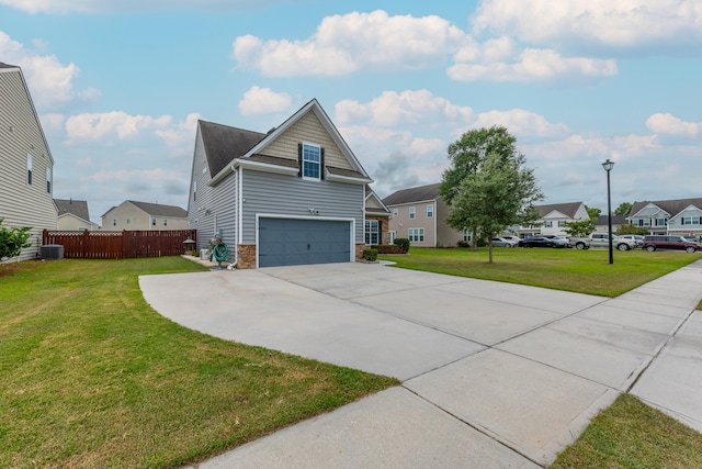 view of front of house featuring a garage, central AC, and a front lawn