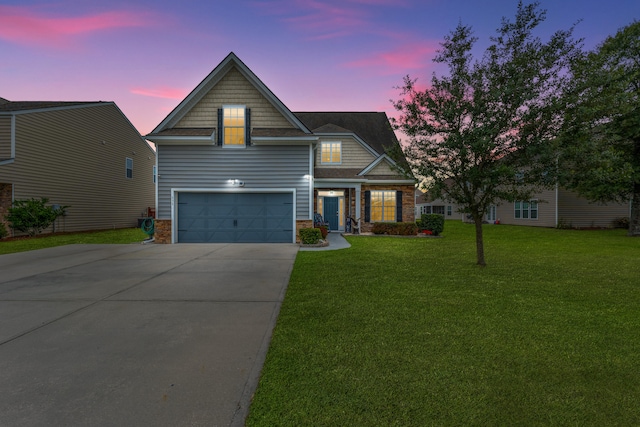 view of front of home with a garage and a lawn