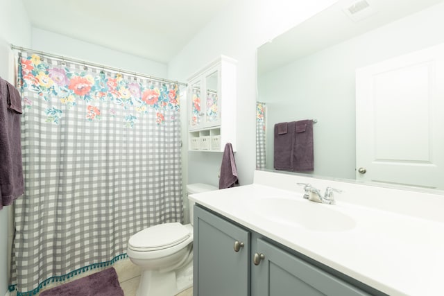 bathroom featuring tile patterned flooring, vanity, and toilet