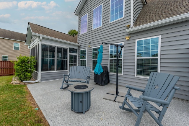 view of patio featuring a fire pit, grilling area, and a sunroom