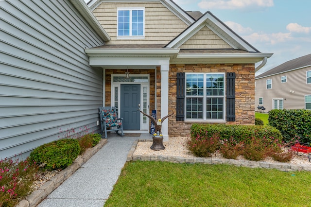 entrance to property featuring a yard