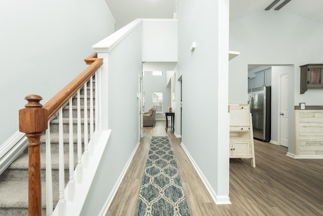 interior space featuring high vaulted ceiling and hardwood / wood-style floors