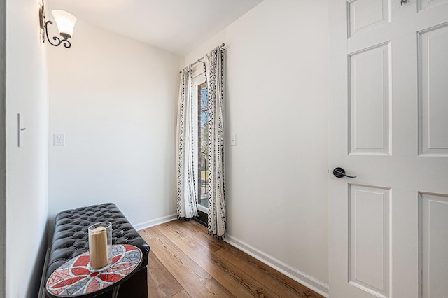 hall featuring baseboards and wood finished floors