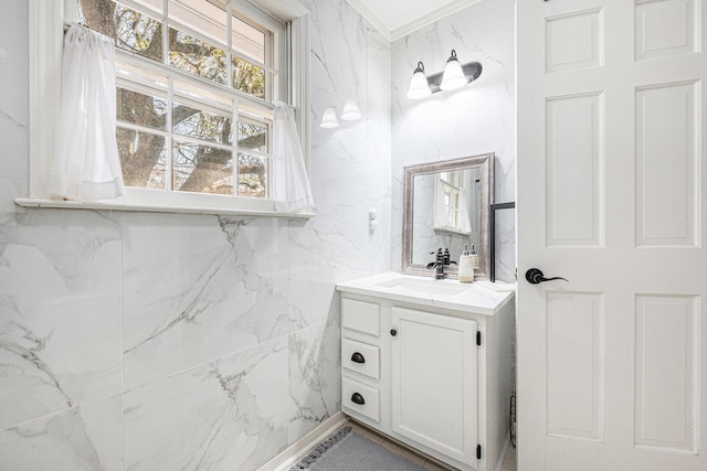 bathroom featuring ornamental molding, tile walls, and vanity