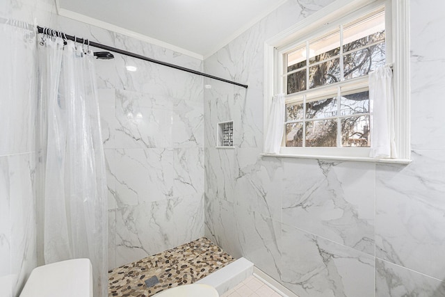 bathroom featuring ornamental molding, a marble finish shower, and toilet