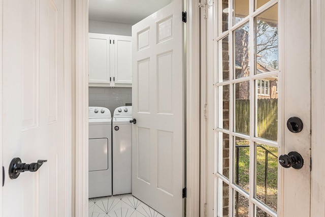 laundry room with cabinet space, washing machine and dryer, and light tile patterned flooring