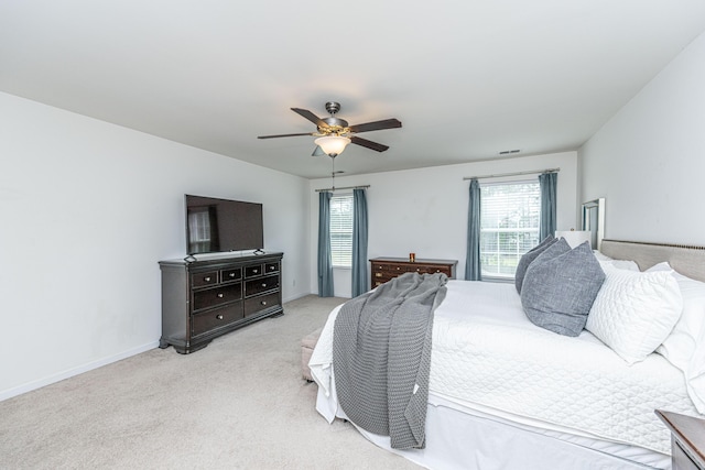 bedroom with multiple windows, carpet flooring, ceiling fan, and visible vents