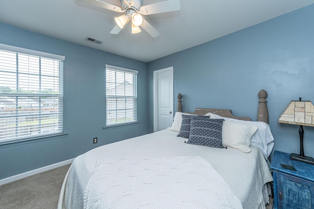 carpeted bedroom featuring a ceiling fan, baseboards, and visible vents