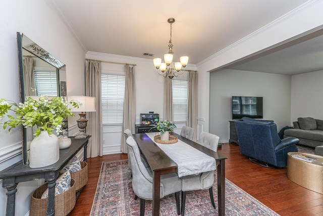 dining area with visible vents, ornamental molding, dark wood finished floors, and a notable chandelier