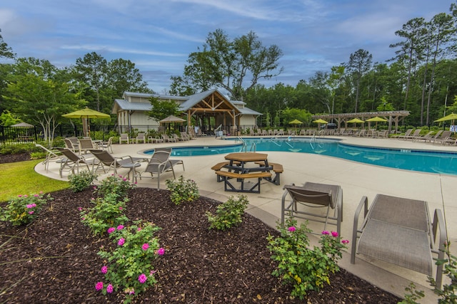 community pool featuring a patio, fence, and a pergola