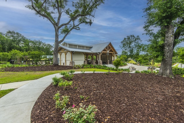 view of front of property with fence and metal roof