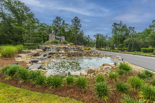 view of swimming pool with a garden pond
