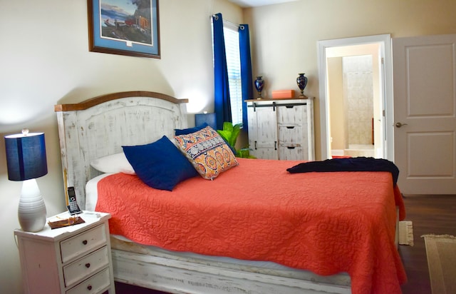 bedroom featuring hardwood / wood-style flooring and ensuite bathroom