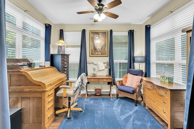 office with ceiling fan, plenty of natural light, and dark wood-type flooring