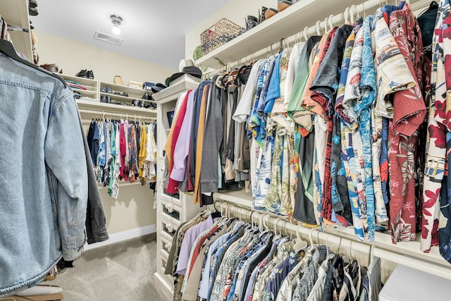 walk in closet featuring light colored carpet