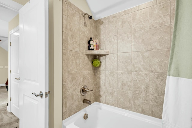 bathroom with lofted ceiling and shower / bath combo with shower curtain