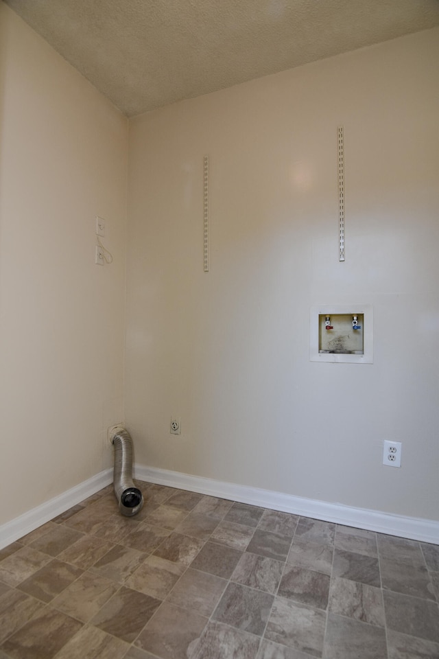 laundry room featuring washer hookup and a textured ceiling