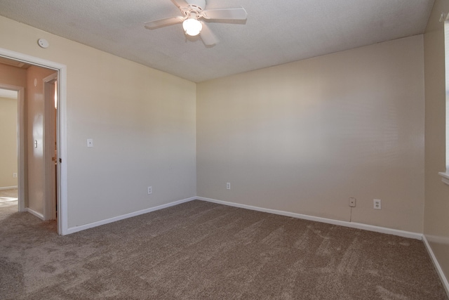 spare room featuring ceiling fan, carpet floors, and a textured ceiling