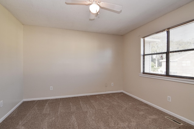 spare room with ceiling fan, carpet floors, and a textured ceiling