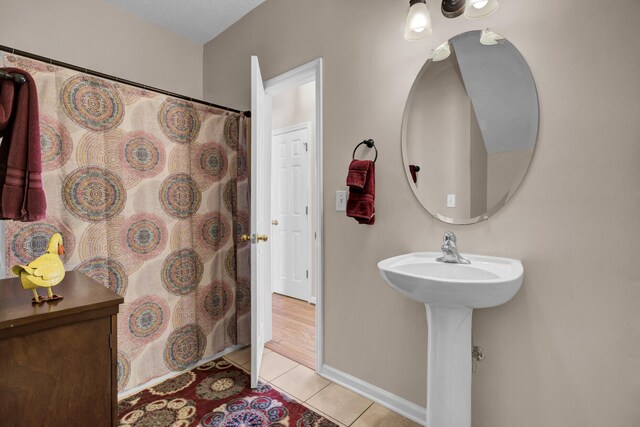 30 Regency Oaks Dr, Summerville, SC 29485 - full bathroom with tile patterned flooring, a shower with shower curtain, baseboards, and a sink