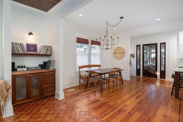 dining area featuring dark hardwood / wood-style flooring and a chandelier