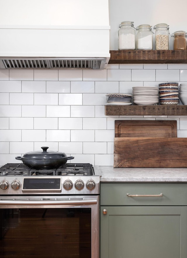 kitchen featuring decorative backsplash, stainless steel gas stove, and exhaust hood