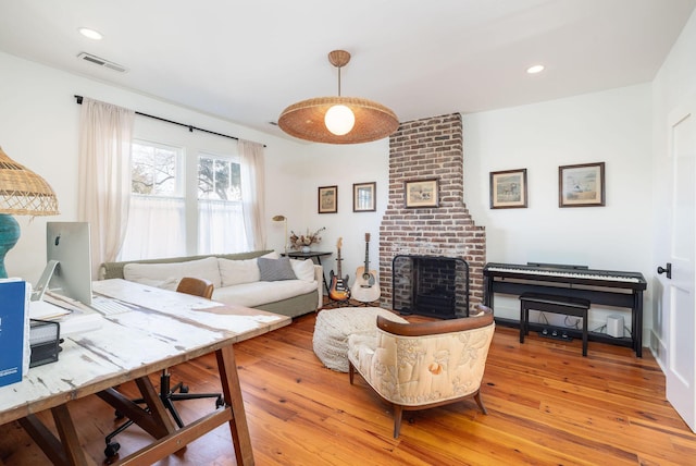 living room featuring wood-type flooring and a fireplace