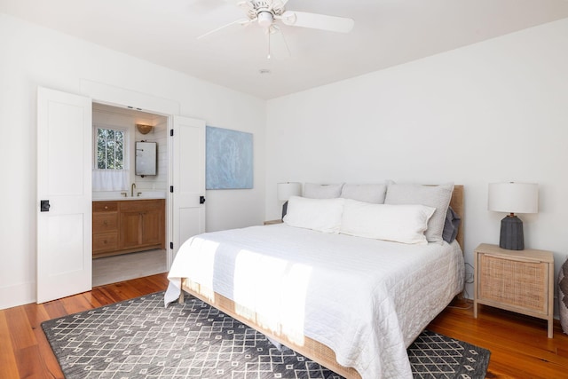 bedroom featuring ceiling fan, ensuite bathroom, and hardwood / wood-style floors