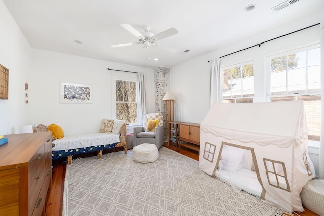 living area with ceiling fan and hardwood / wood-style flooring