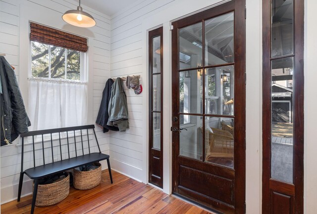 interior space with wood walls and hardwood / wood-style floors