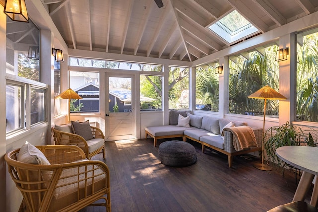 sunroom featuring lofted ceiling with skylight and a wealth of natural light