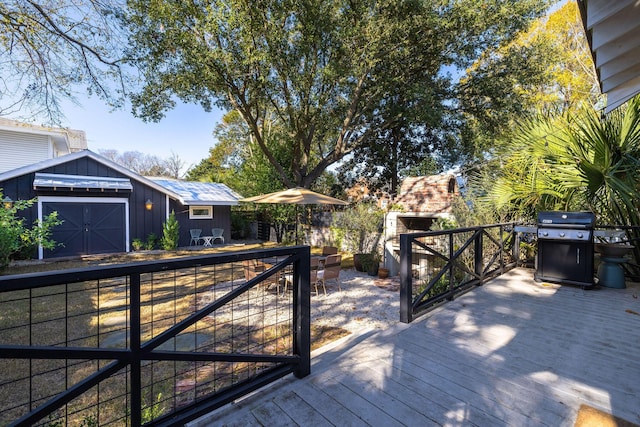 deck featuring an outbuilding and a grill