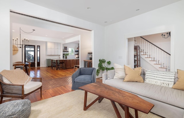 living room featuring hardwood / wood-style flooring and a notable chandelier