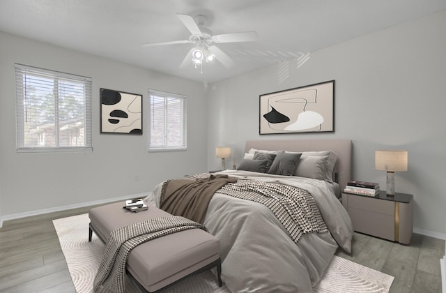 bedroom with light hardwood / wood-style flooring and ceiling fan