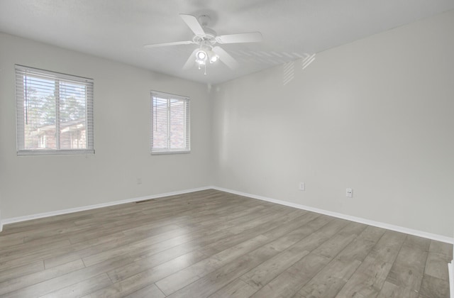 empty room with light wood-type flooring and ceiling fan