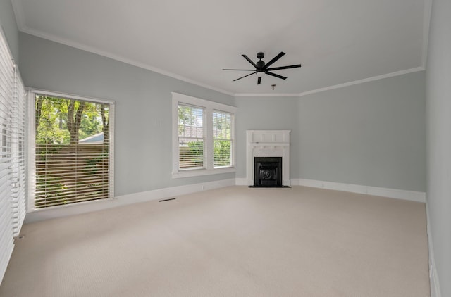 unfurnished living room with carpet, ornamental molding, ceiling fan, and a fireplace