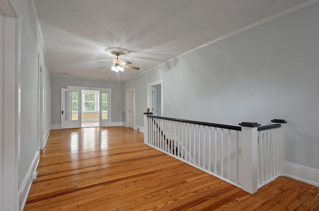 hall featuring ornamental molding and light hardwood / wood-style flooring