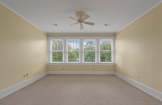 unfurnished room with ceiling fan, carpet floors, and crown molding