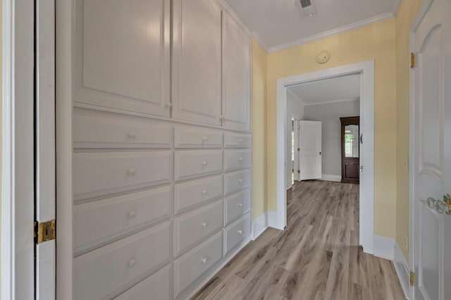 hall featuring light hardwood / wood-style floors and crown molding