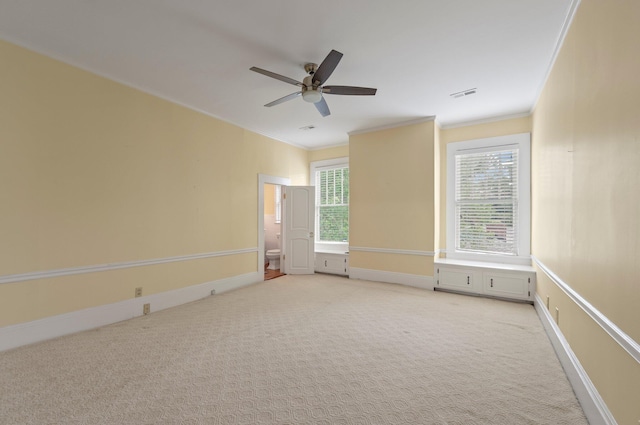 carpeted empty room featuring ornamental molding and ceiling fan