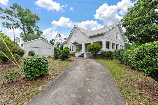 view of front of house featuring an outdoor structure, a porch, and a garage