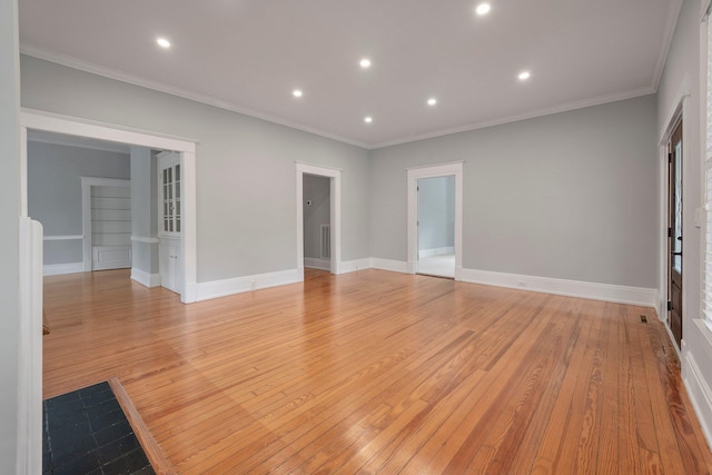 unfurnished room featuring ornamental molding and light wood-type flooring