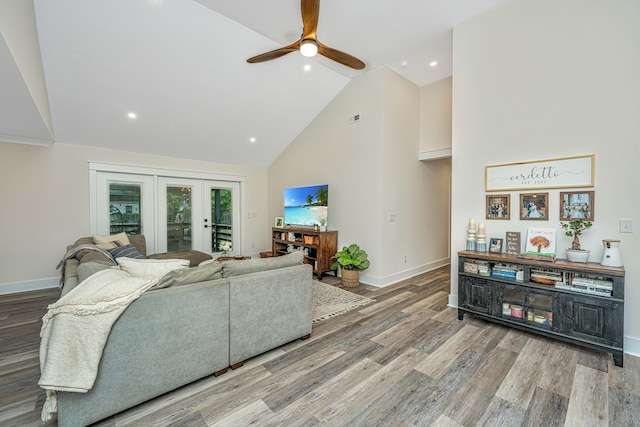 living room featuring high vaulted ceiling, hardwood / wood-style floors, ceiling fan, and french doors