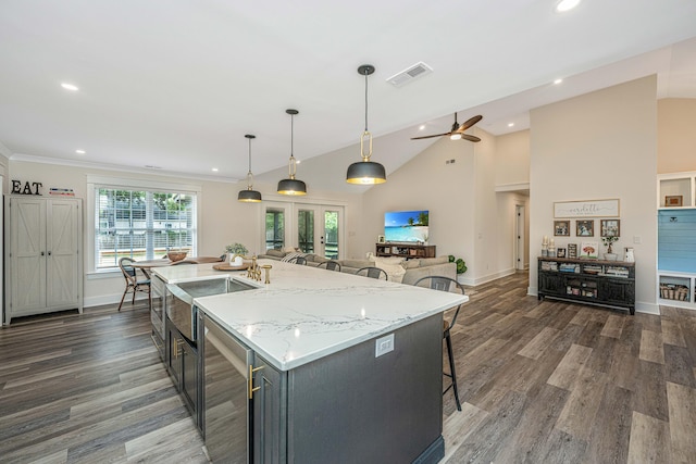 kitchen featuring wine cooler, ceiling fan, decorative light fixtures, dark hardwood / wood-style flooring, and a kitchen island with sink