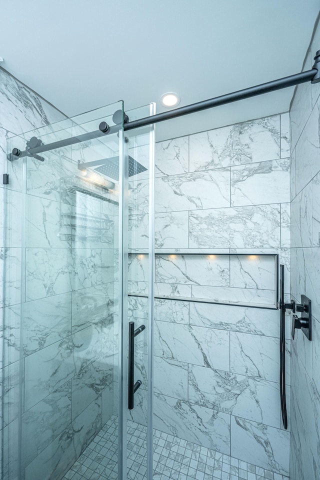 bathroom featuring a shower with shower door