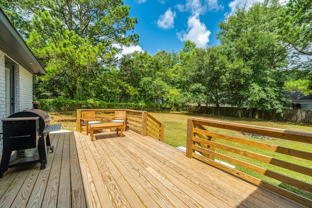 wooden deck with area for grilling and a lawn